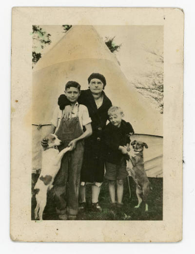 Artist unidentified, “Untitled [Group portrait of woman, two children, and two dogs in front of…